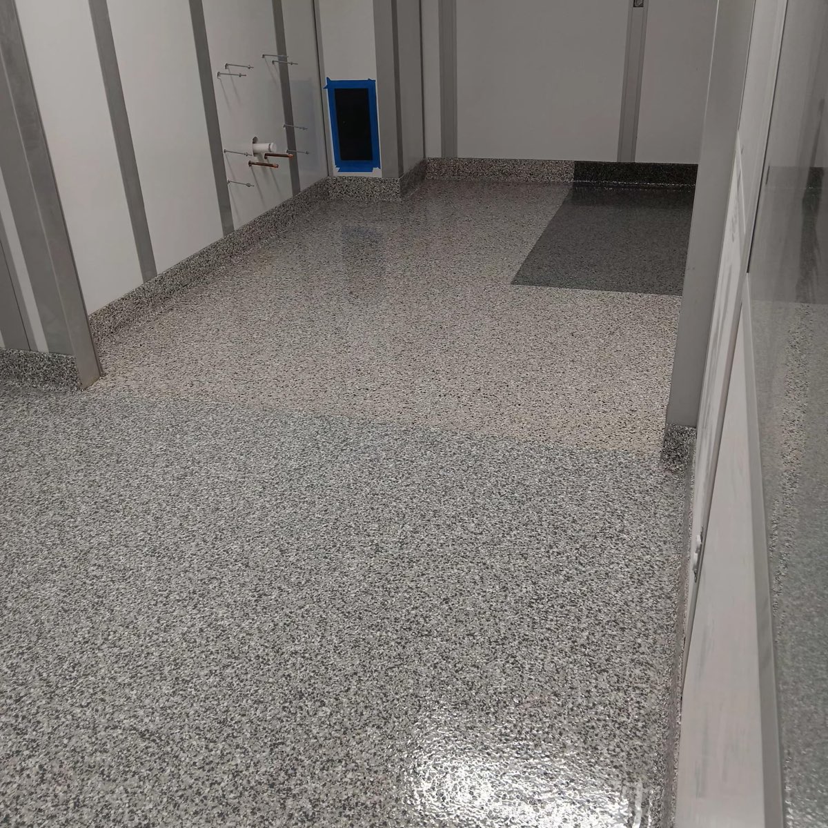 Seamless gray flake clean room floor with integral cove base and color-separated zones at a Florida hospital